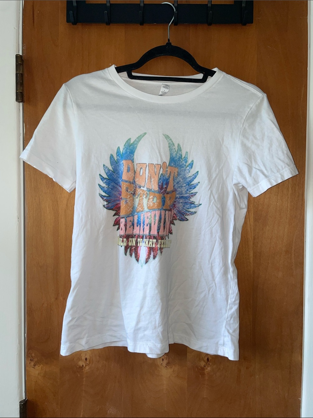 White Graphic Tee with Colorful Winged Design